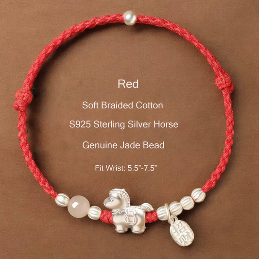 Red braided cotton bracelet with silver horse charm and jade bead on a brown background