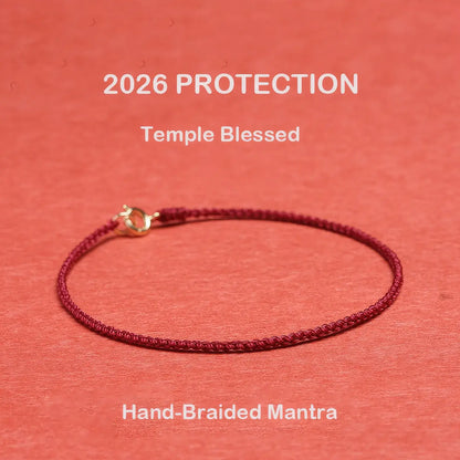 Hand-braided mantra bracelet on a red background with '2026 Protection' text.