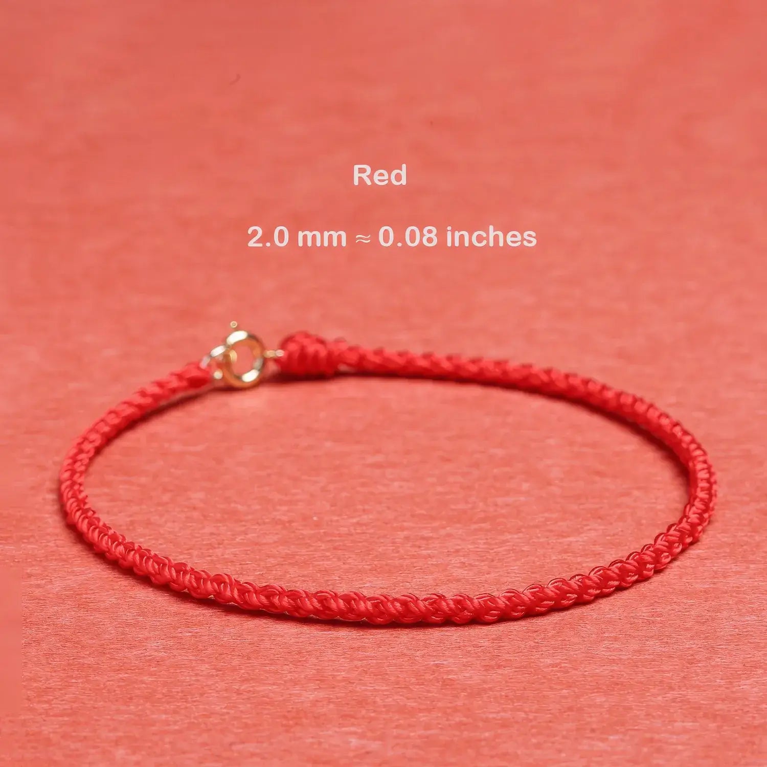 Red bracelet with gold clasp on a red background