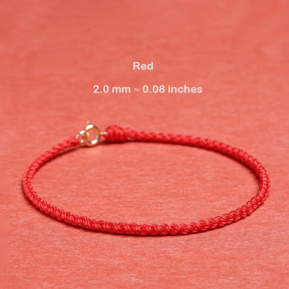 Red bracelet with gold clasp on a red background