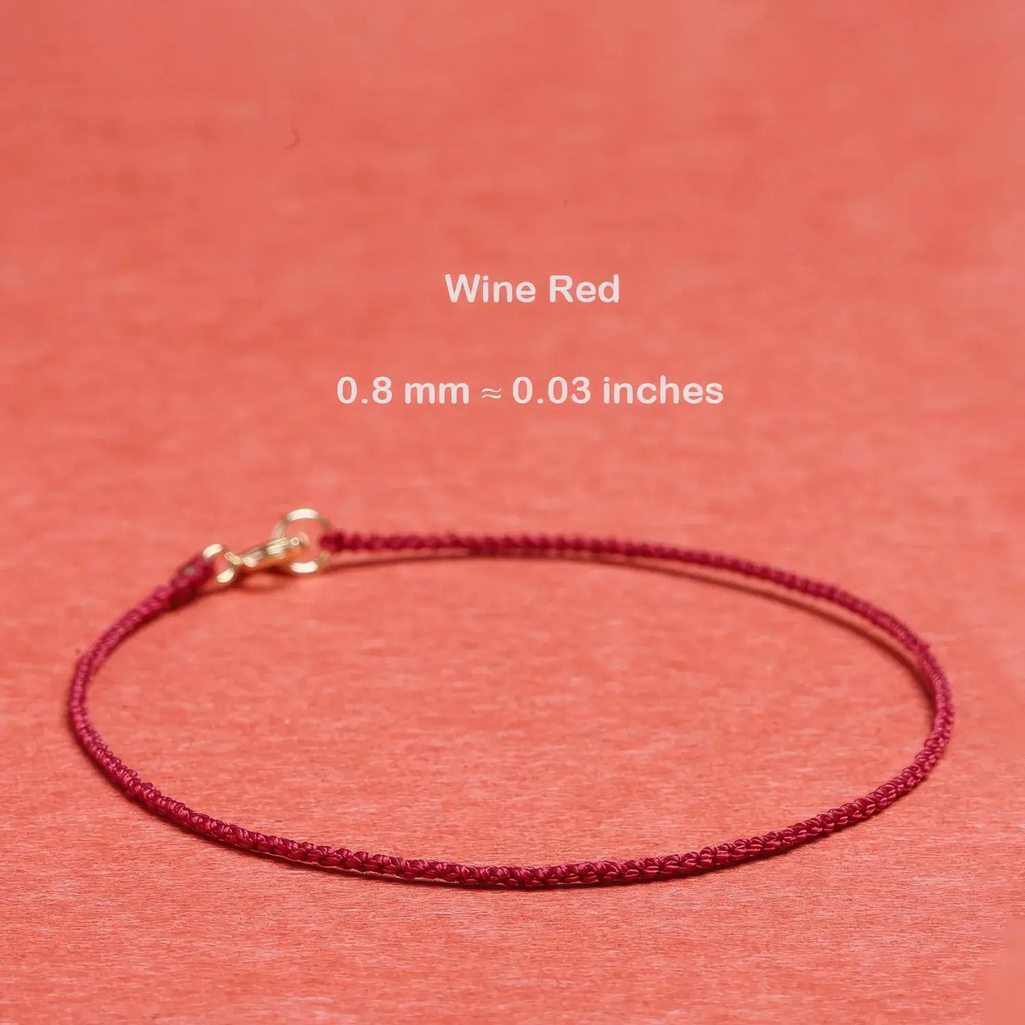 Wine red cord bracelet on a matching background with text indicating thickness.