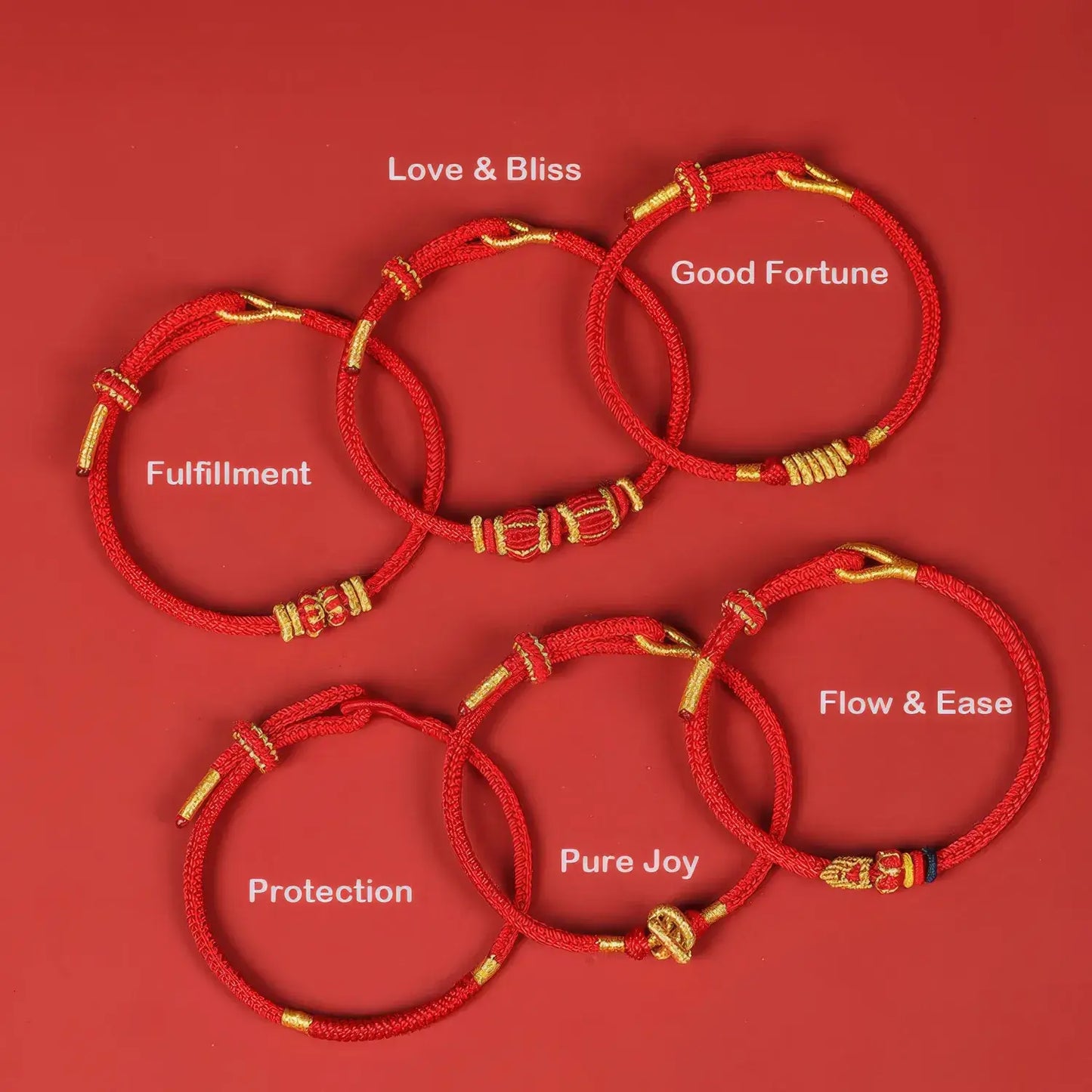 Set of red bracelets with gold accents on a red background, each labeled with a different blessing.
