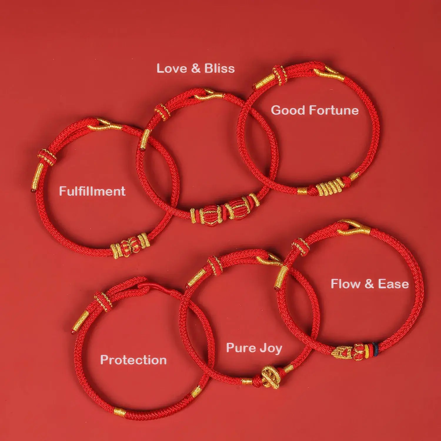 Set of red bracelets with gold accents on a red background, each labeled with a different blessing.