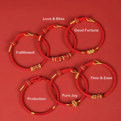Set of red bracelets with gold accents on a red background, each labeled with a different blessing.