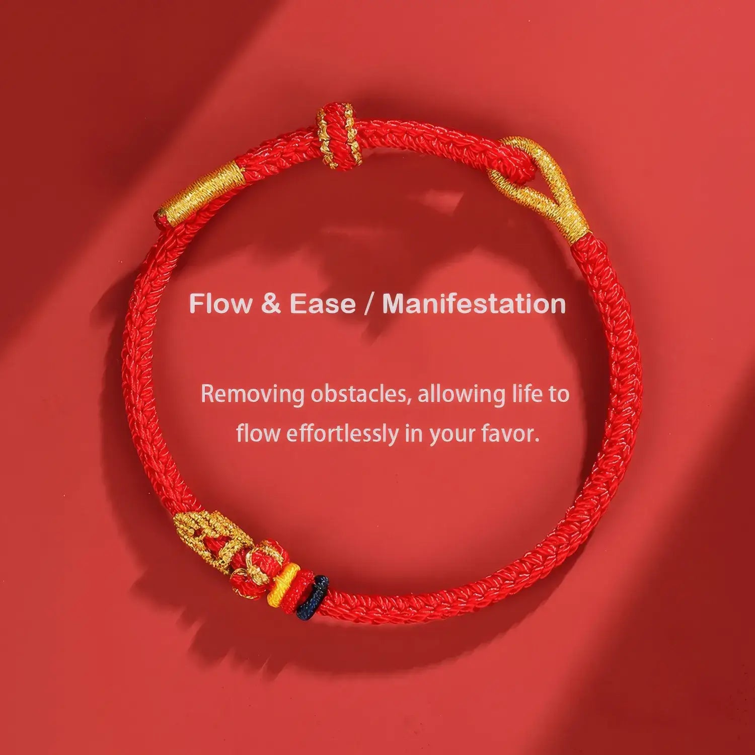 Red and gold bracelet on a red background with text about 'Flow & Ease/Manifestation'.