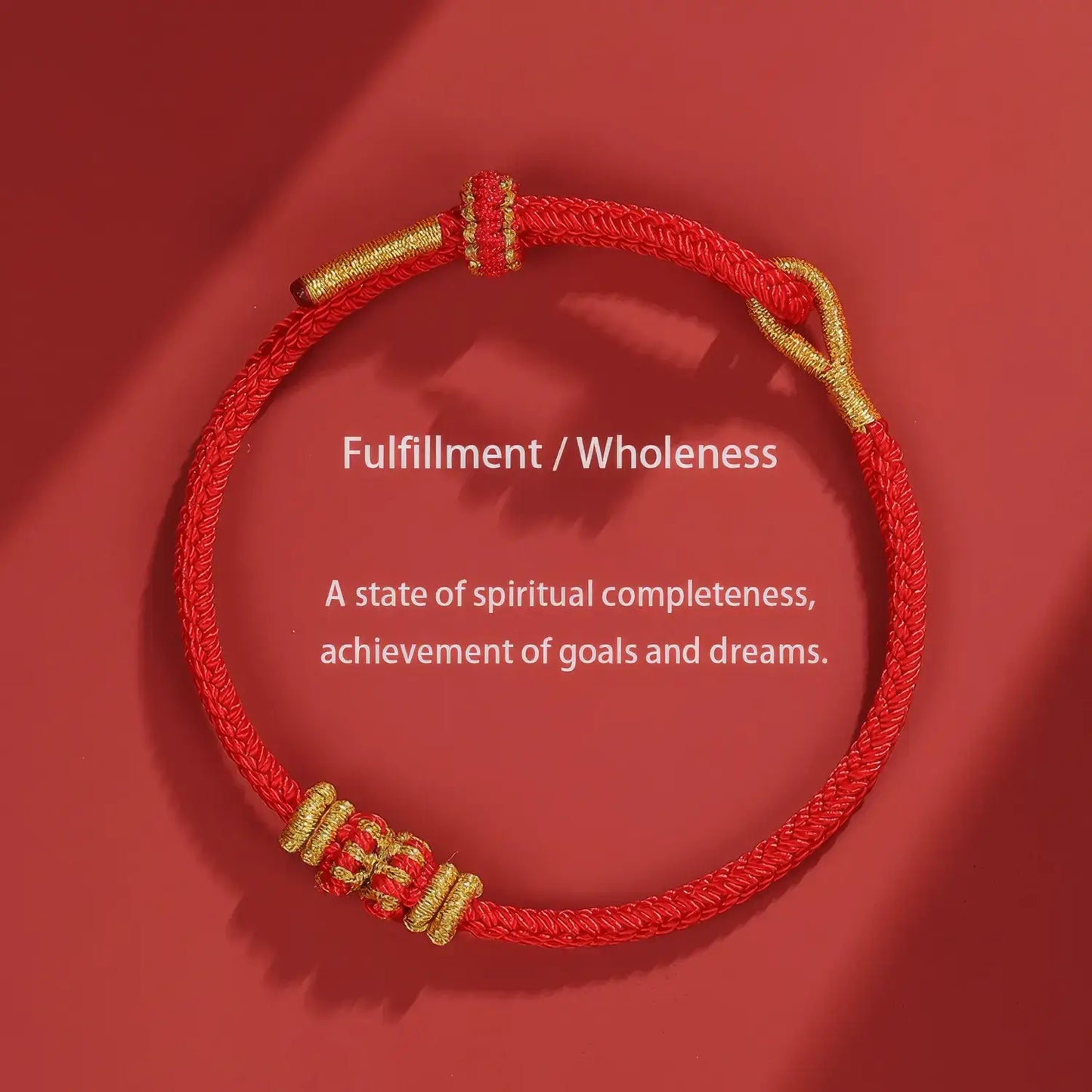 Red and gold bracelet on a red background with text about fulfillment and wholeness.