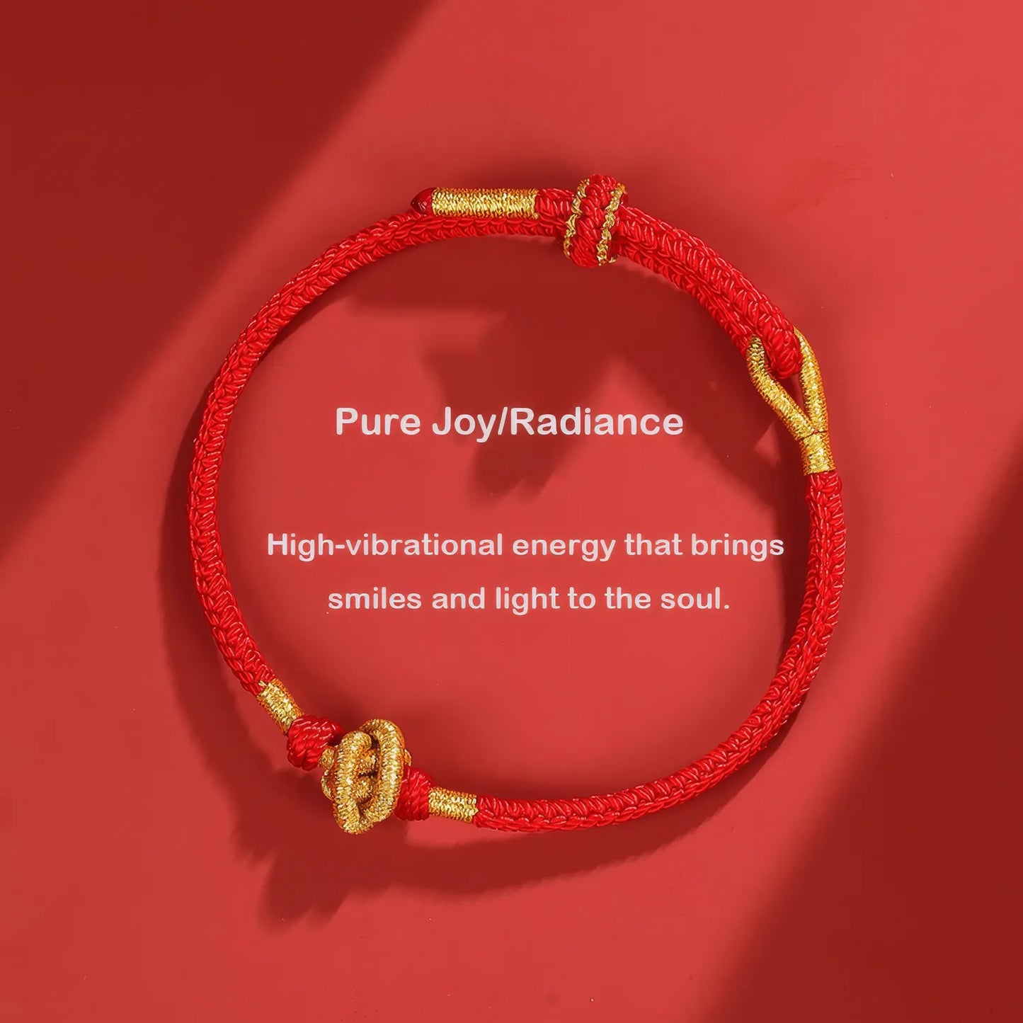 Red bracelet with gold accents on a red background, featuring text about high-vibrational energy.