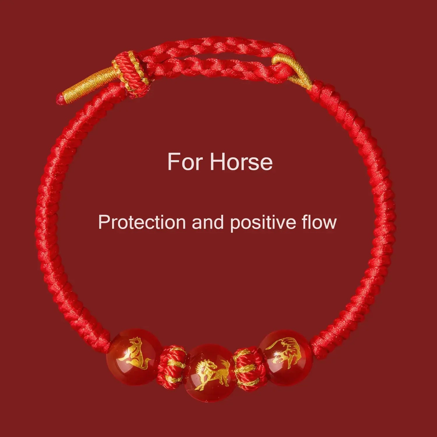 Red bracelet with gold accents and horse designs on a red background