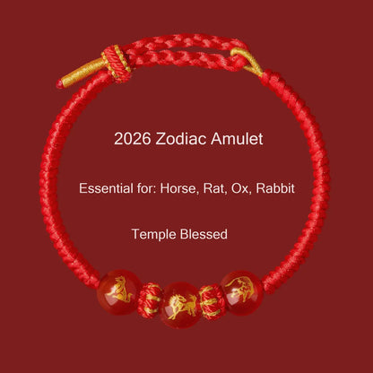 Red zodiac amulet bracelet with gold accents on a red background