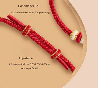 Red hand-woven knot bracelet with gold accents on a beige background