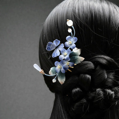 Hair accessory with blue flowers on a braided hairstyle against a gray background