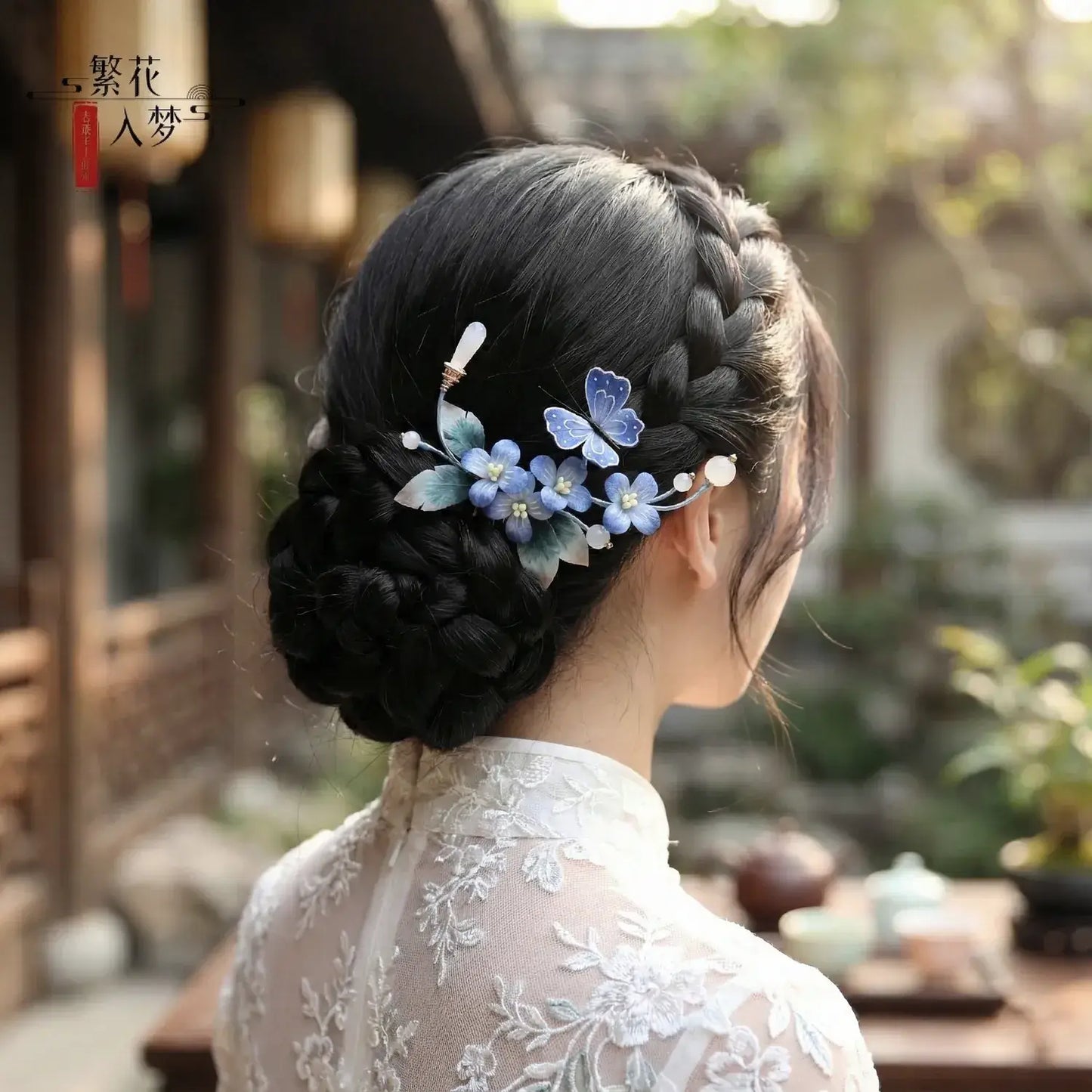 Traditional hairstyle with floral hairpins in a blurred outdoor setting