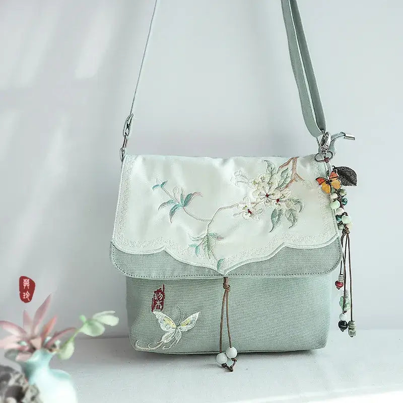 Embroidered handbag with floral designs on a light background