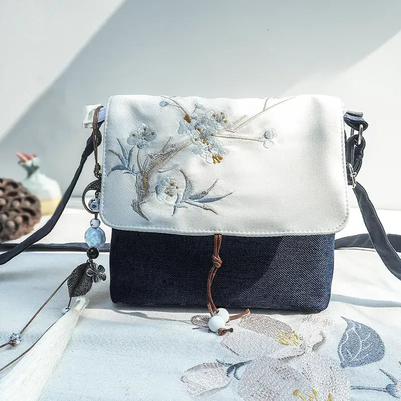 Handbag with floral embroidery on a light background