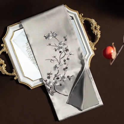 Decorative tray with floral embroidery on a dark background
