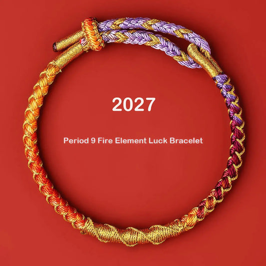 A braided cord bracelet arranged in a circle on a solid red background, with white text reading '2027' and 'Period 9 Fire Element Luck Bracelet.' The bracelet combines gold, orange, purple, and red braided sections.