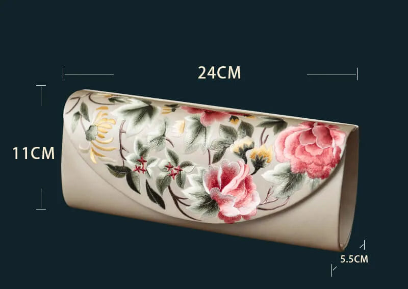 Floral-patterned clutch bag with measurements on a dark background