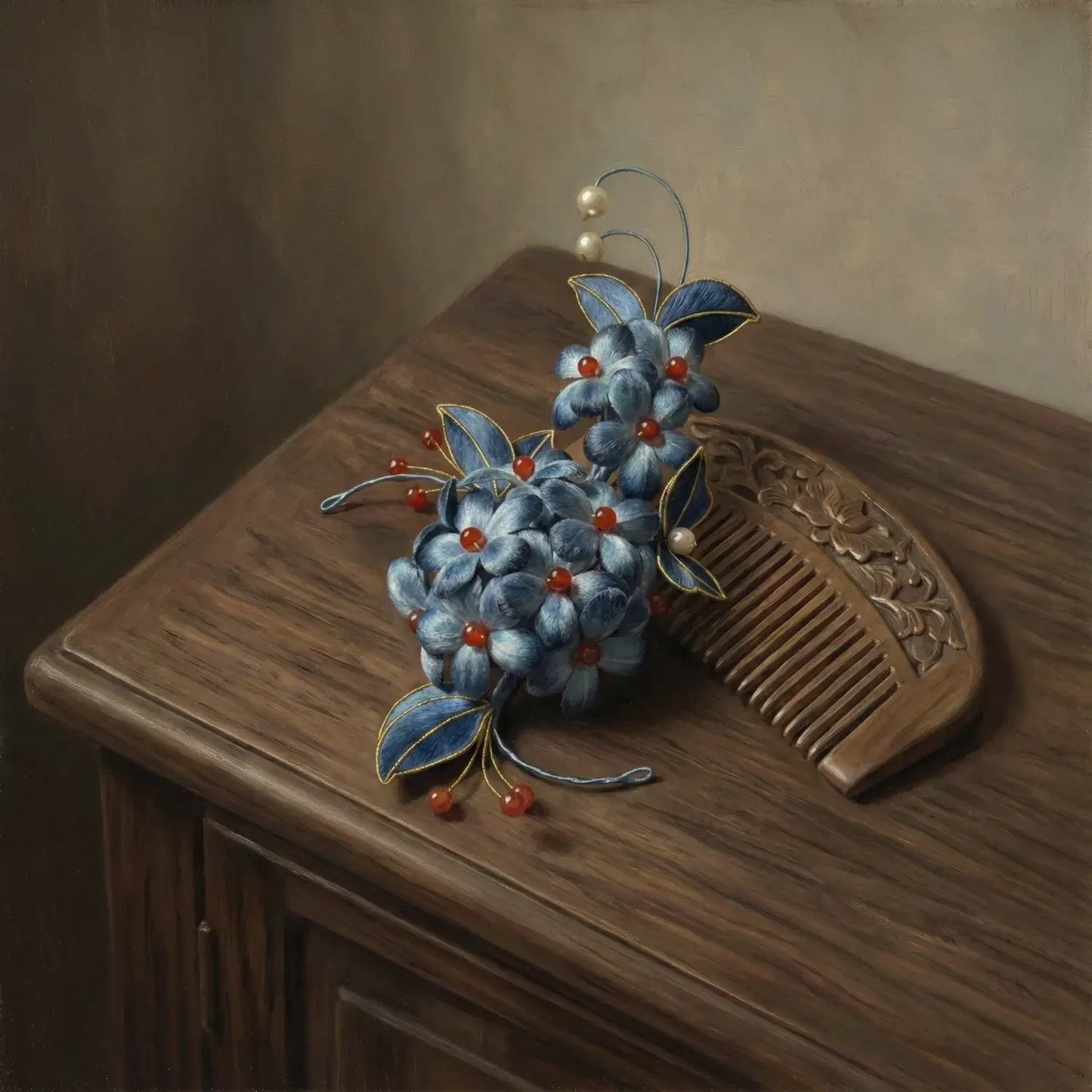 Decorative hair comb with blue flowers and red berries on a wooden surface