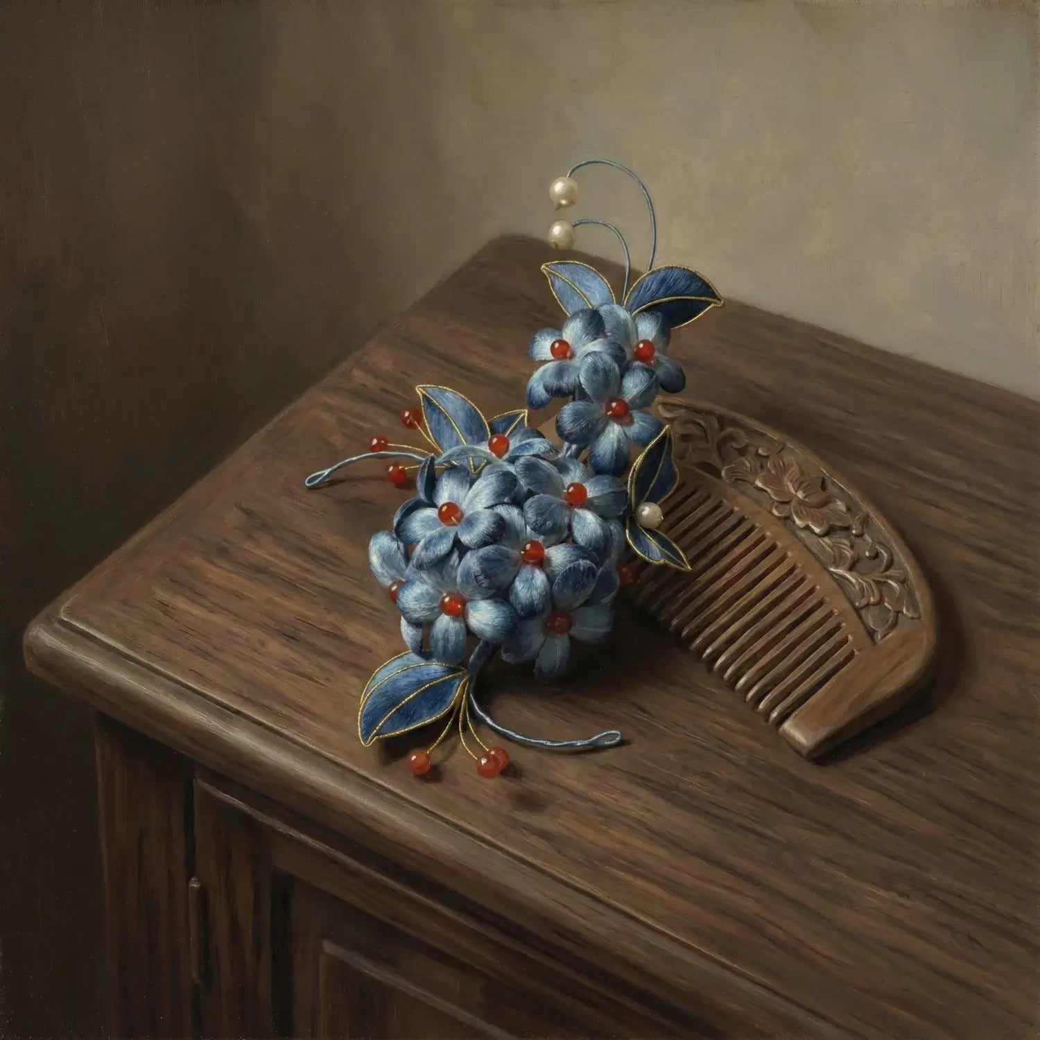 Decorative hair comb with blue flowers and red berries on a wooden surface