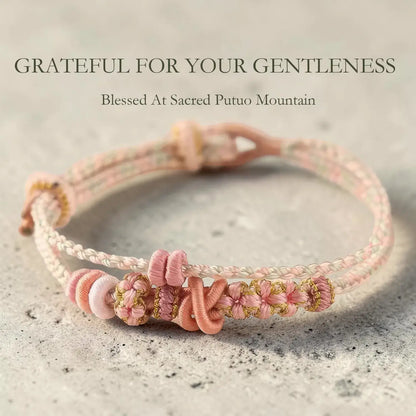 Pink and gold braided bracelet on a textured surface with text overlay.