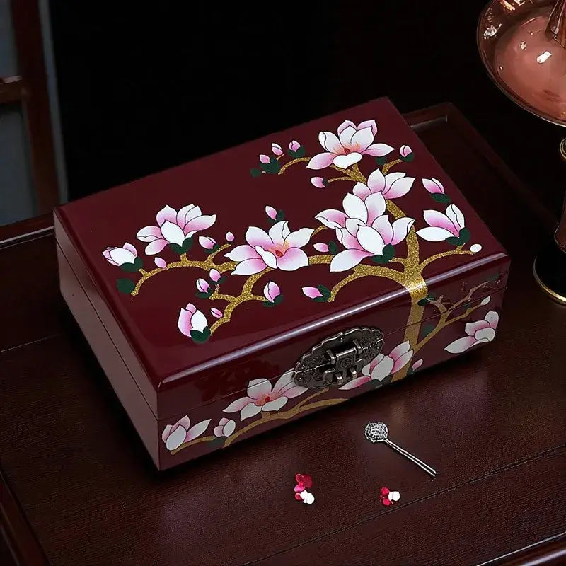 Decorative jewelry box with floral design on a wooden surface