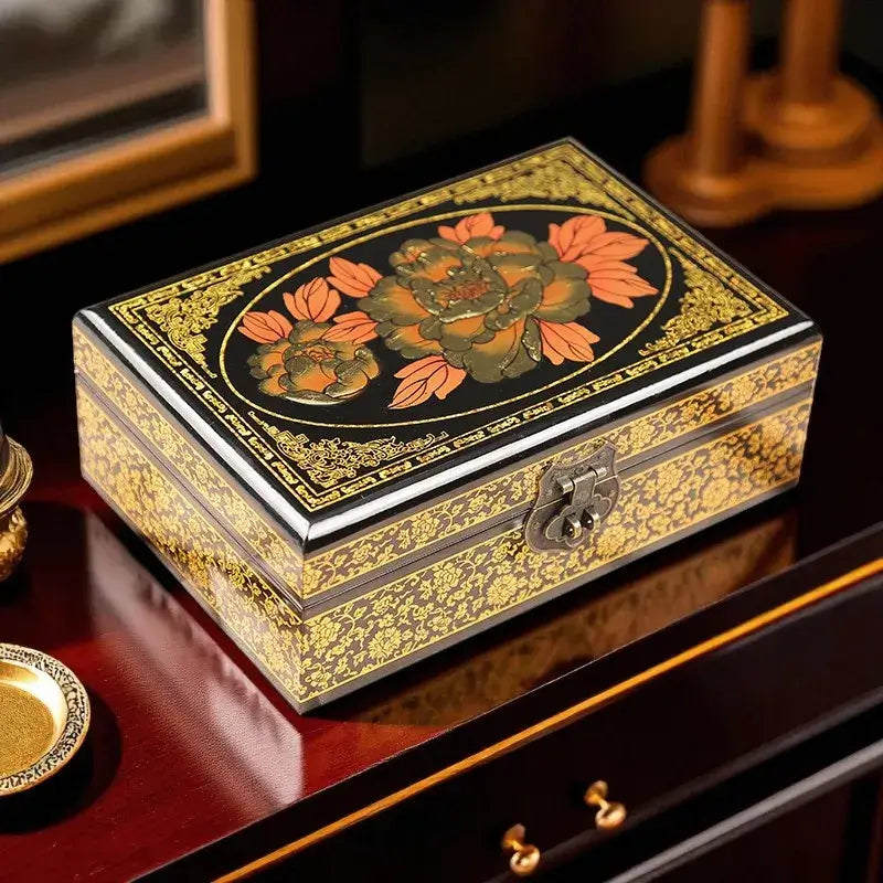 Decorative jewelry box with floral design on a reflective surface