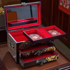 Decorative jewelry box with open lid and compartments on a wooden surface.