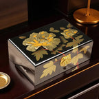 Decorative jewelry box with floral design on a wooden surface