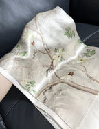 Floral patterned fabric with leaves and flowers on a dark background