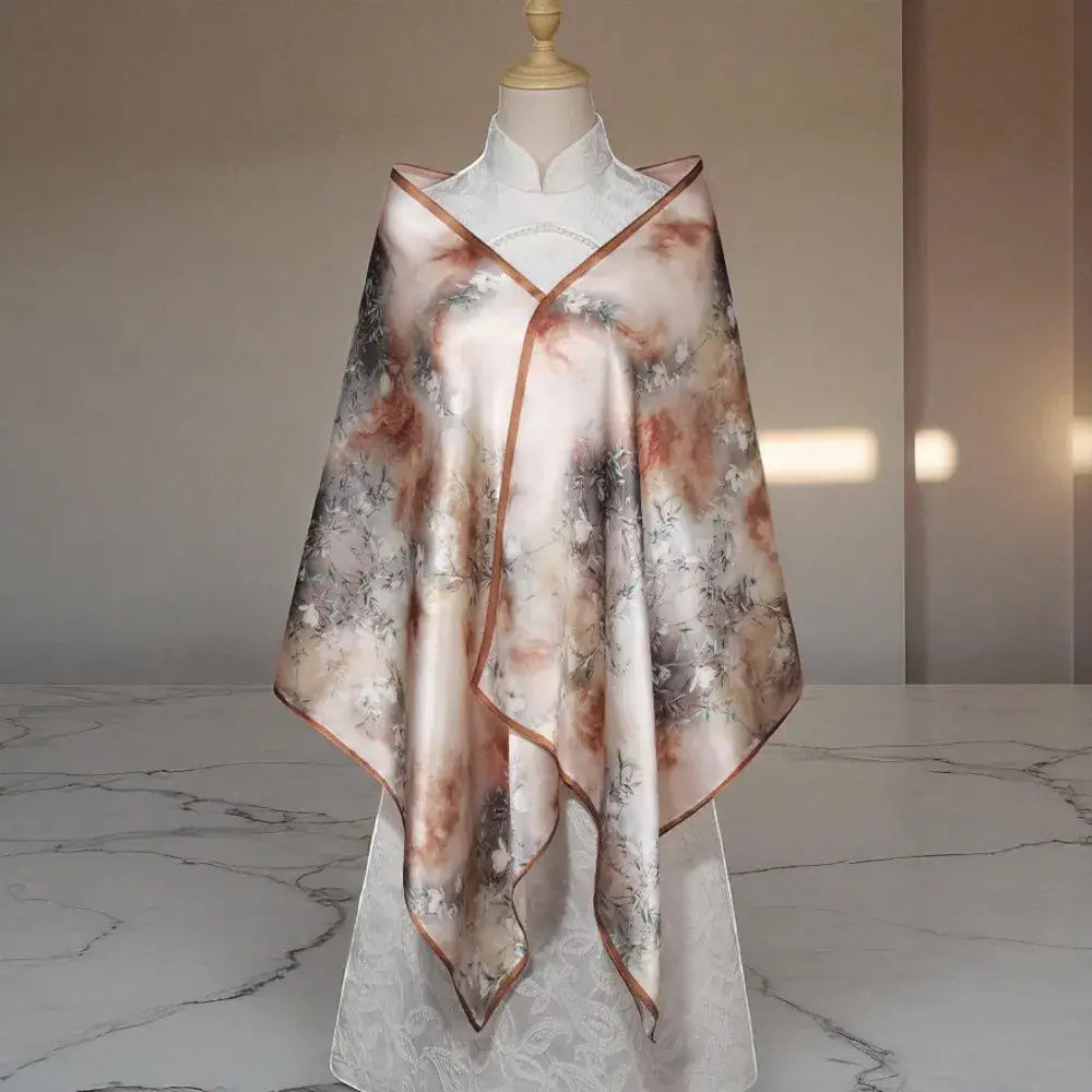 Mannequin wearing a floral-patterned scarf on a marble floor