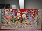 Decorative box with floral and bird patterns on a plain background