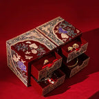 Decorative jewelry box with intricate designs on a red background
