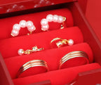Pearl and gold jewelry set in a red jewelry box