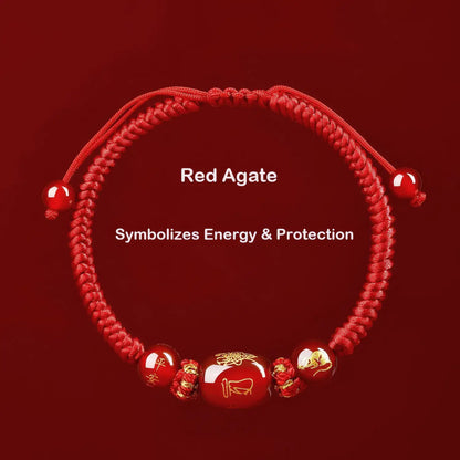 Red agate bracelet with symbolic beads on a red background