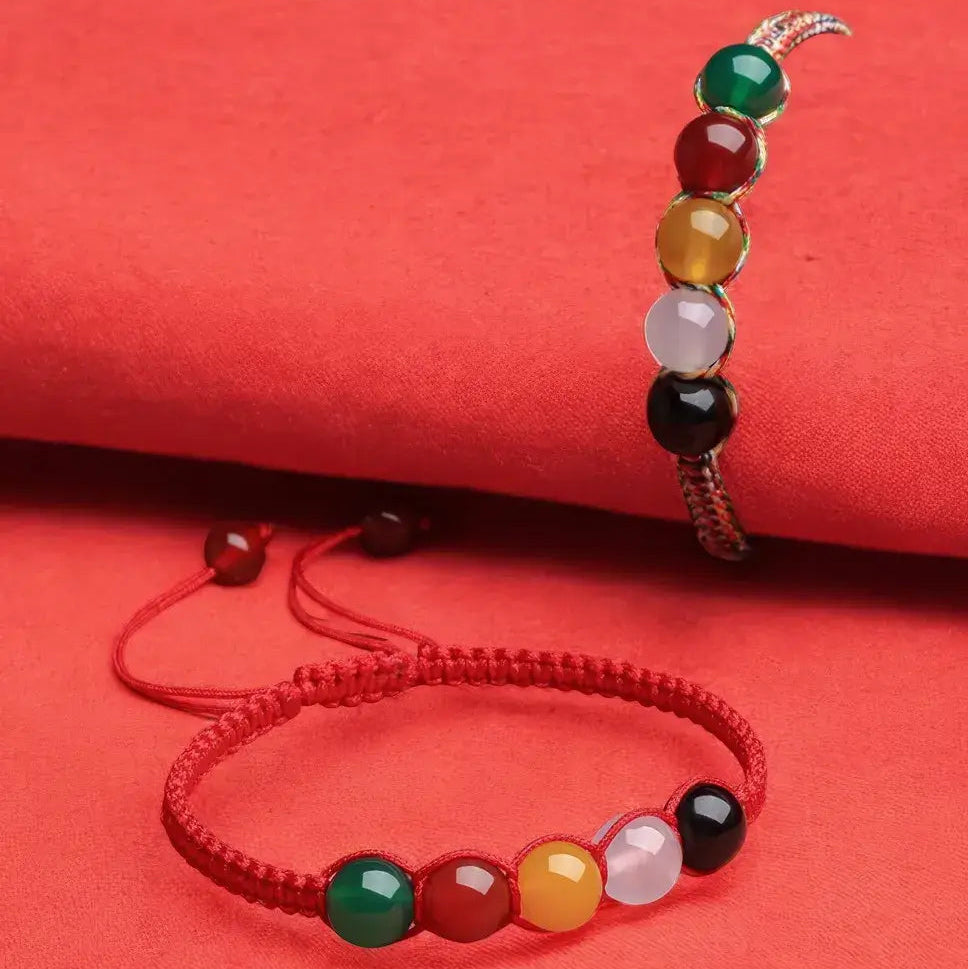 Two beaded bracelets on a red background with mindfulness wisdom text.