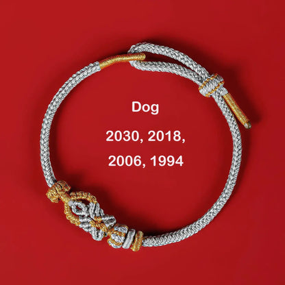 Bracelet with gold and silver accents on a red background, featuring years and the word 'Dog'.