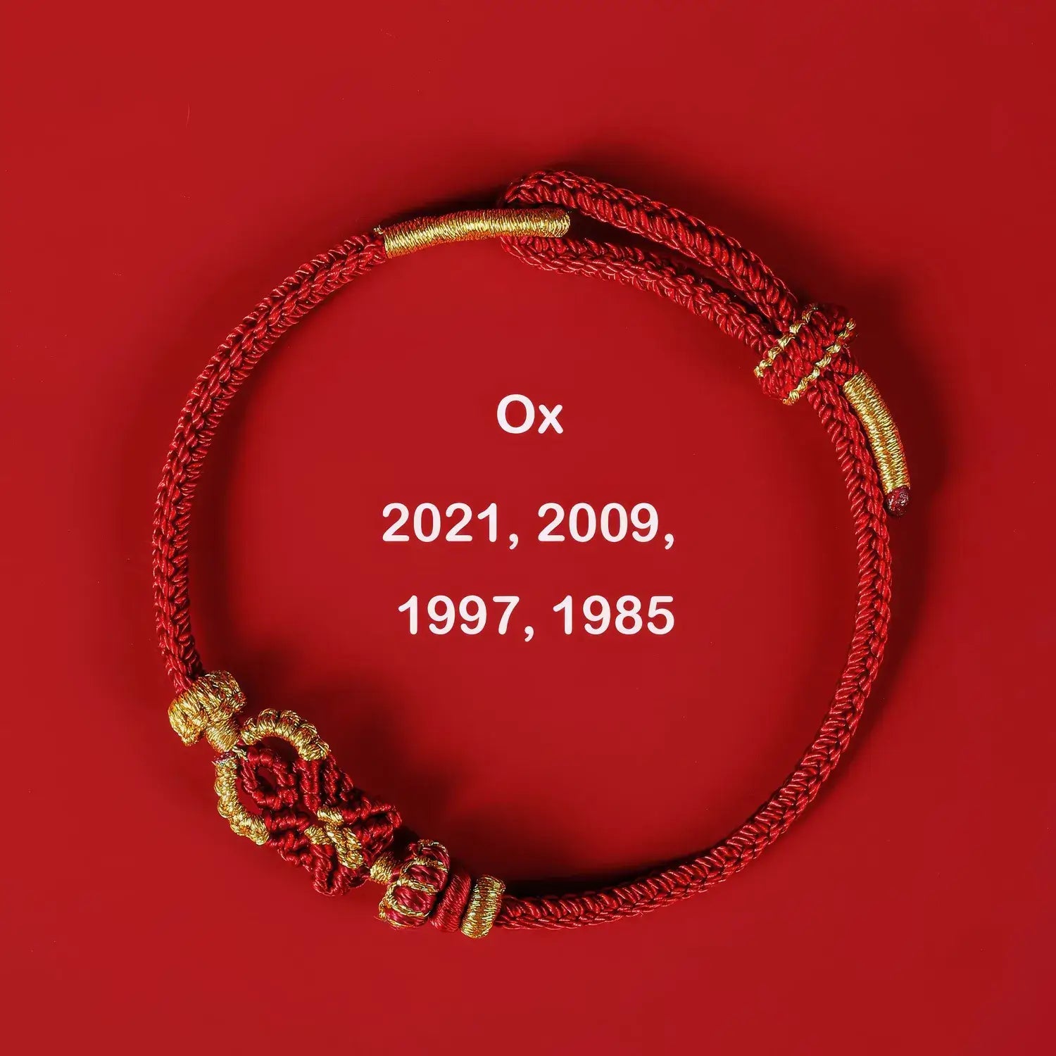Red and gold bracelet on a red background with 'Ox' and years displayed.