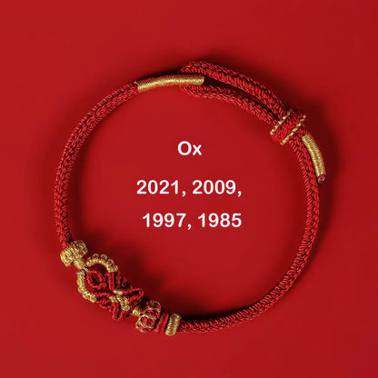 Red and gold bracelet on a red background with 'Ox' and years displayed.