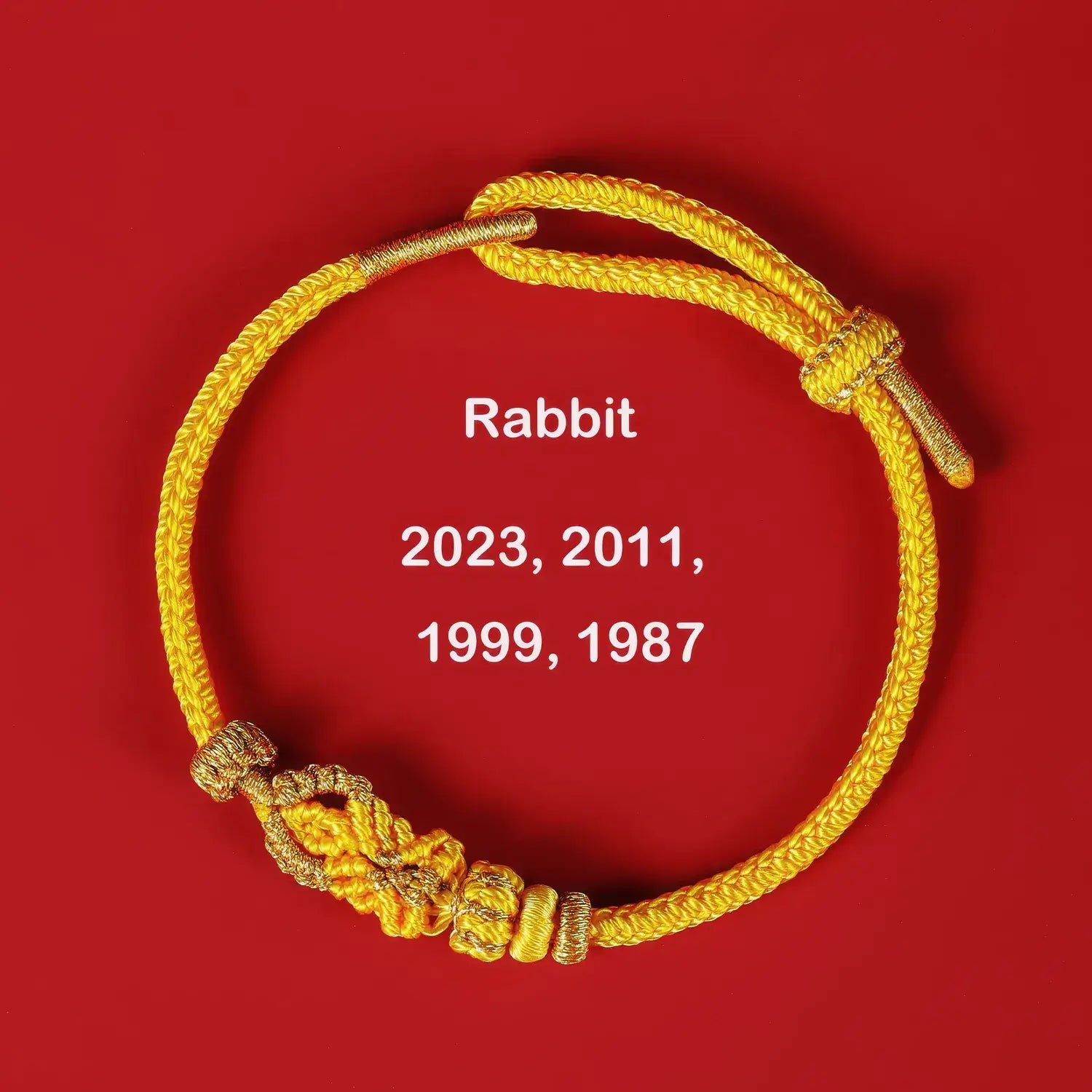 Gold bracelet with year markings on a red background