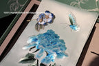 Handcrafted blue brooches on a decorative surface with floral design.