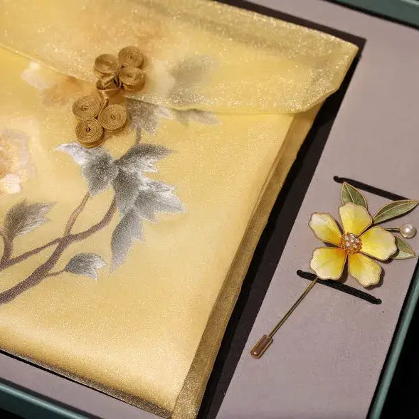 Decorative brooch with floral design on a matching fabric background