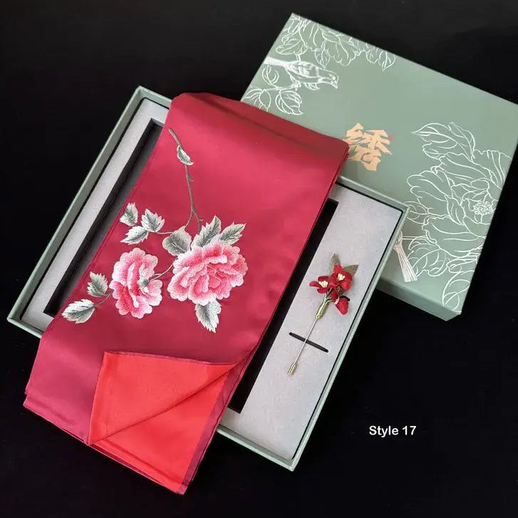 Red embroidered fabric with floral design in a box on a black background