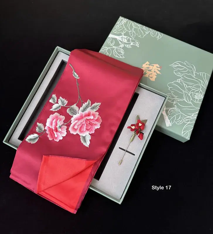 Red embroidered fabric with floral design in a box on a black background