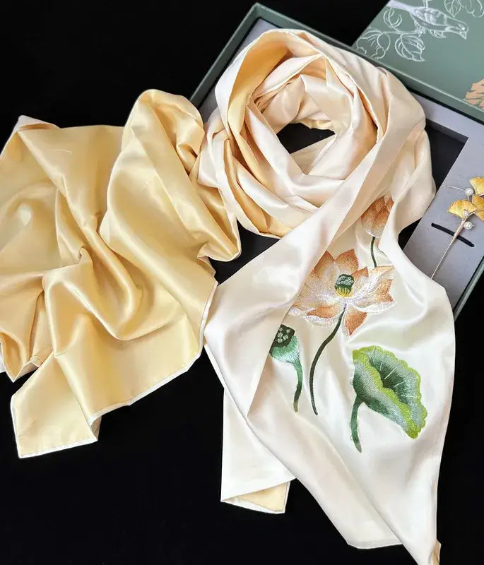 Beige scrunchie and floral scarf on a black background