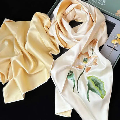 Beige scrunchie and floral scarf on a black background