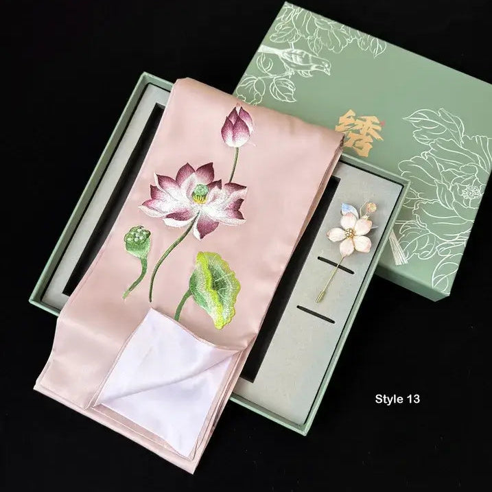 Embroidered pink fabric with floral design in a green box on a black background