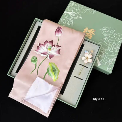 Embroidered pink fabric with floral design in a green box on a black background