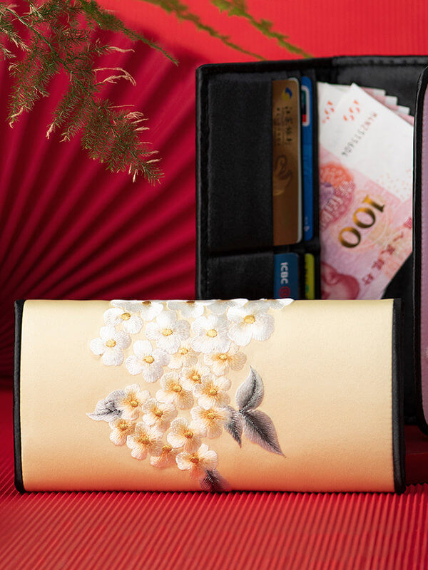 Hand-painted wallet with floral design on a red background
