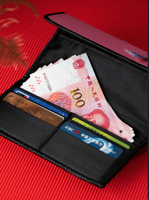Black wallet with banknotes and cards on a red background