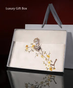 Luxury gift box with decorative brooch and floral design on a dark background